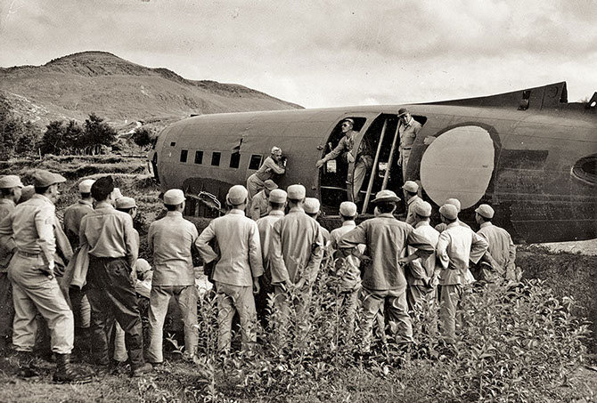 Chinese Commandos receive instruction on how to jump from a C-47 drop aircraft.  The OG instructors used a crashed C-47 as a mock-up.