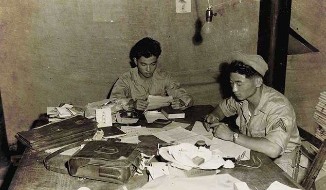 Two Nisei work on a project for the Morale Operations section in OSS Detachment 101, Burma, 1945. 
